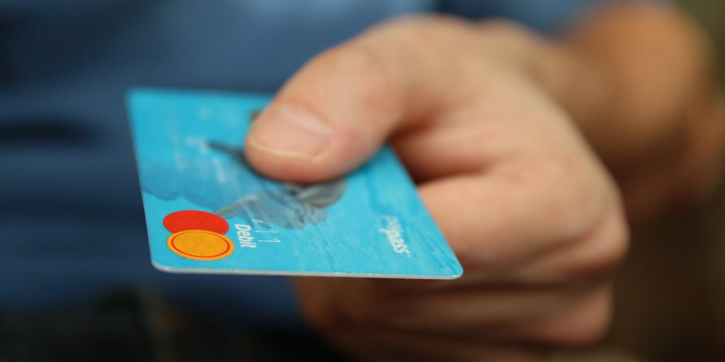 person holding Credit Card
